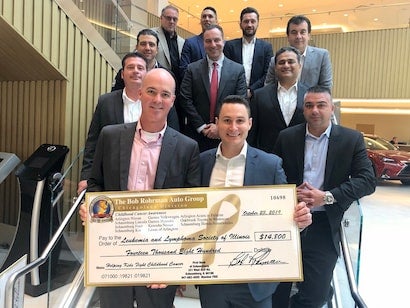 staff holding donation check