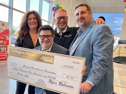 staff holding donation check