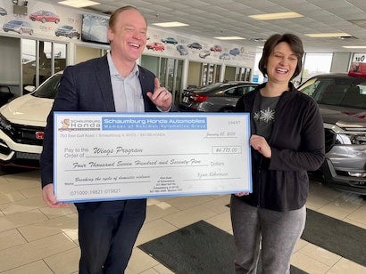 staff holding donation check